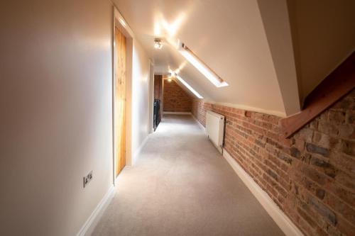 a hallway in a house with a brick wall at The Granary in Martin