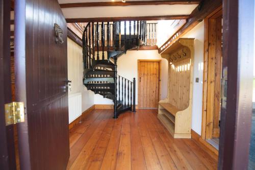 a hallway with a spiral staircase in a house at The Granary in Martin