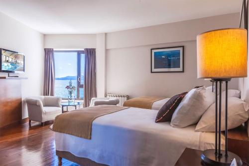 a hotel room with a bed and a window at Sheraton Bariloche Hotel in San Carlos de Bariloche