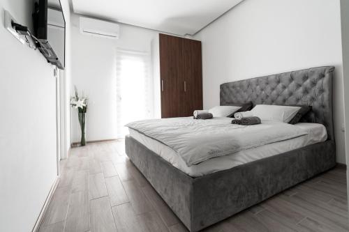 a bedroom with a large bed and a flat screen tv at ADA MOMENT Splav- kuca na reci Beograd- Floating House on SAVA RIVER ,Belgrade in Belgrade