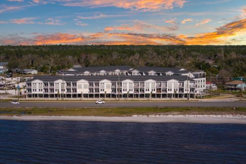 a large building on the beach next to the water at Port Paradise in Highland View