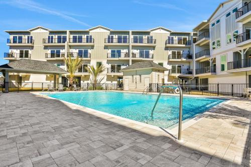 a swimming pool in front of a apartment building at Port Paradise in Highland View