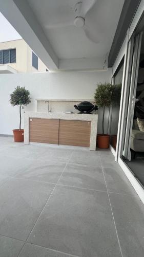 a kitchen with a counter and two potted plants at Luxury apartment Black Pearl Beluga with private Pool and Jacuzzi in Novalja