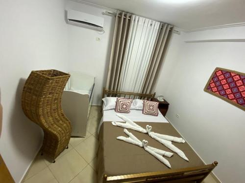a room with a bed with baseball bats on it at Olive Tree Apartment in Sarandë