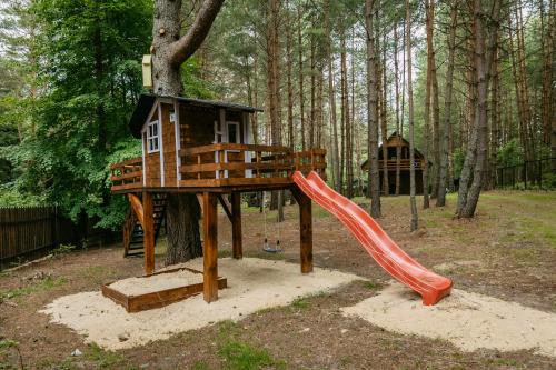 a playground with a slide and a tree house at Lesna Kryjowka Roztocze in Rybnica