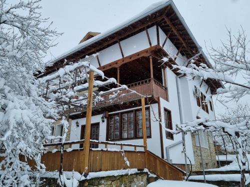 a house covered in snow at Arbanassi Hotel in Arbanasi