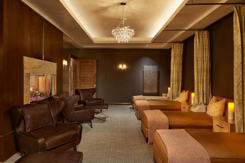 a waiting room with a bunch of chairs and a waiting roomasteryasteryasteryastery at St. Regis Aspen Resort in Aspen