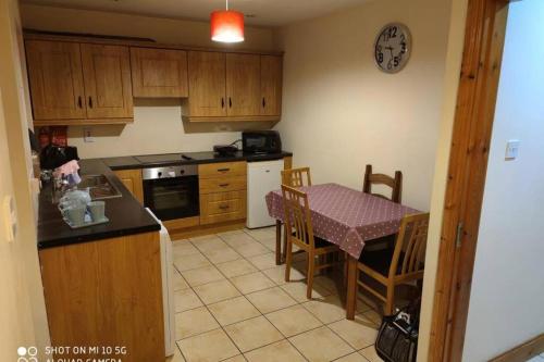 a kitchen with a table and a table and a dining room at Townhouse 1 Barrow Lane in Bagenalstown