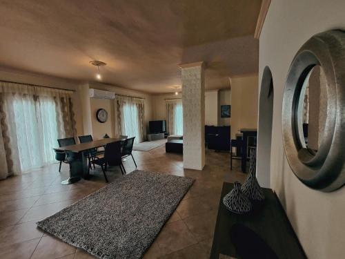 a living room with a table and a dining room at Morfi Serenity Retreat in Parga