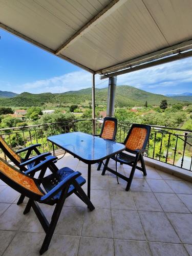 a table and chairs on a patio with a view at Morfi Serenity Retreat in Parga