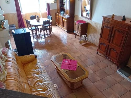 a living room with a couch and a table at Maison de campagne in Brinon-sur-Beuvron
