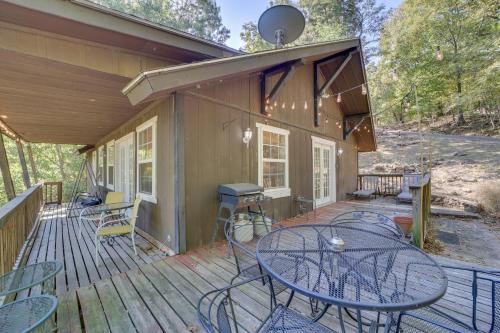 a patio with a table and chairs on a deck at Secluded Vian Retreat Close to Tenkiller Lake in Vian