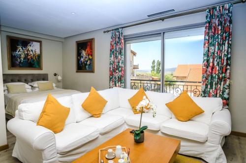 a living room with a white couch with yellow pillows at Le Palais des Cerisiers in Azrou
