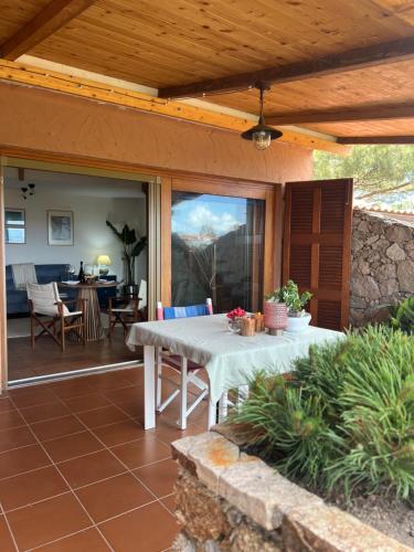 a patio with a table and a dining room at Casa Bougainvillea in Casa Azara