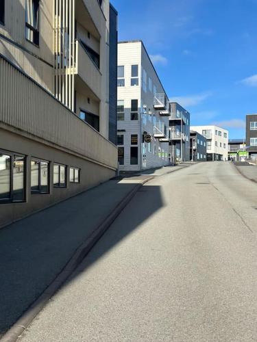 an empty street in front of a building at Faroe Stay Apartments, No.1 in Hoyvík