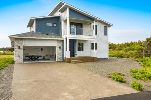 a house on the beach with a driveway at Pelican Cove in Westport