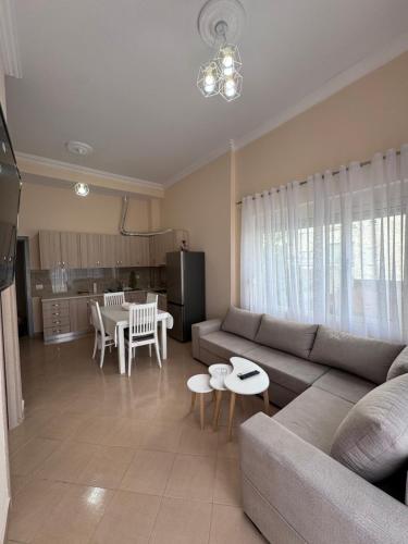 a living room with a couch and a table at Durres Lovely Apartment with Balcony in Durrës
