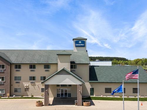 a building with a clock tower on top of it at Boarders Inn & Suites by Cobblestone Hotels - Shawano in Shawano