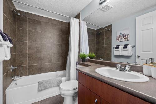 a bathroom with a sink and a tub and a toilet at The Altitude Landing, Pool, Hot Tub, Pets in Invermere
