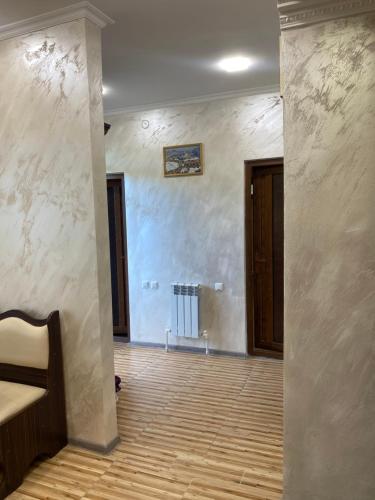 an empty room with a hallway with a wooden floor at Syune House in Tatʼev