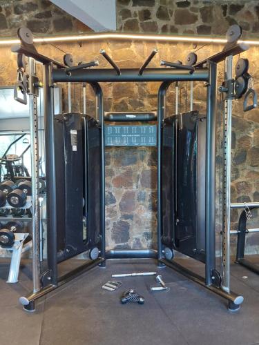 a row of gym equipment in front of a stone wall at Hotel Raices Esturion in Puerto Iguazú
