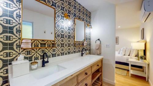 a bathroom with a sink and a large mirror at Mountain View Luxury Nogales Springs Escape in Palm Springs
