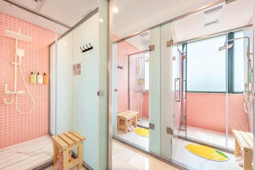 a bathroom with a shower and a glass door at Lemon Hotel - Metro Line 1 Line 7 Changshu Road 200 meters in Shanghai