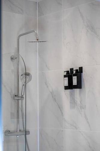 a shower with a glass door in a bathroom at Short Stays, Free Parking, Contractors, Families - Large Home in Durham