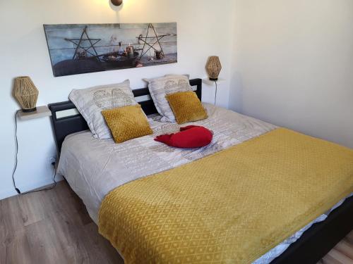 a bedroom with a bed with a red hat on it at Villa l'Eden de Camargue- Spa et Nature in Candillargues