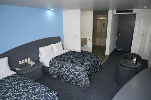 Postel nebo postele na pokoji v ubytování Hotel Concorde Toluca
