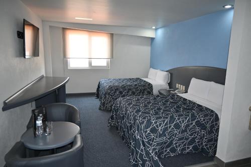 Postel nebo postele na pokoji v ubytování Hotel Concorde Toluca
