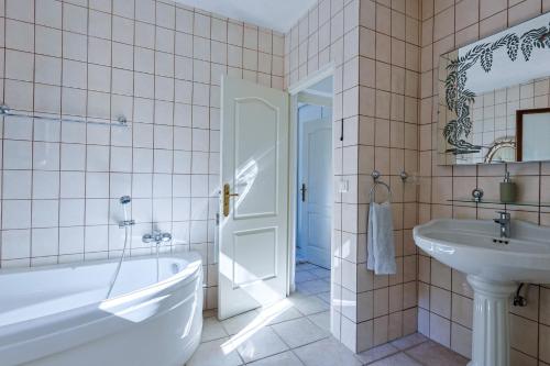 ein Badezimmer mit Badewanne, Waschbecken und Toilette in der Unterkunft Luxus Villa Cristina - mit Pool und Meerblick by Riviera HomeLife in Roquebrune-sur-Argens