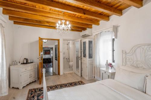 a bedroom with a white bed and a chandelier at Ha La Bodrum in Bodrum City