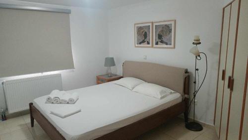 a bedroom with a bed with two towels on it at Melina Apartment - Akoumia Village in Akoumia