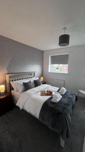 a bedroom with a large bed and a window at Florence house in Thornaby on Tees