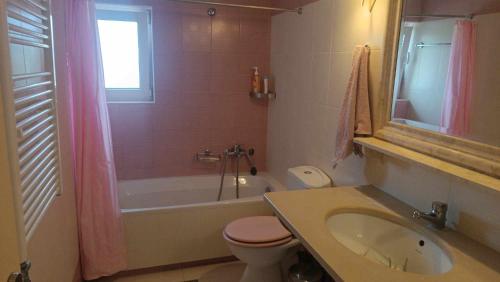 a bathroom with a sink and a toilet and a tub at Melina Apartment - Akoumia Village in Akoumia