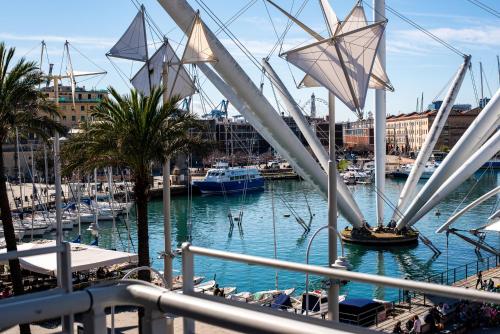 a sail boat in a harbor with boats in the water at Genova Centro - Lussuosa Suite Arte e Storia in Genova