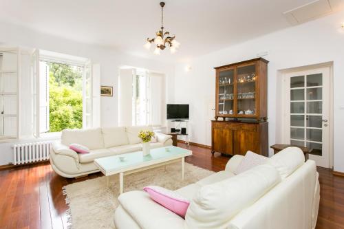 a living room with two white couches and a table at Villa Marini Dvori - with free parking in Dubrovnik