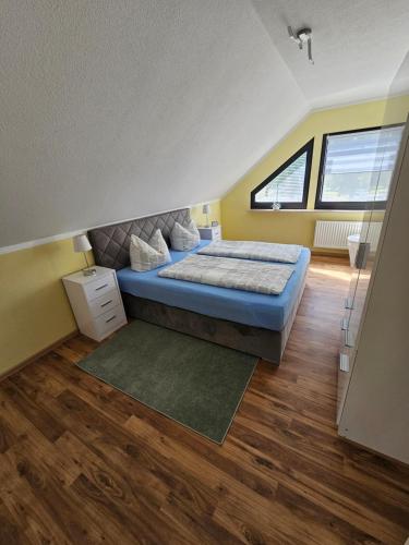 a bedroom with a bed in a room at Haus am Bodden in Fuhlendorf
