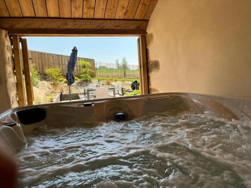 a bath tub filled with water in a room at Maison Au Bout Du Pre in Goulven