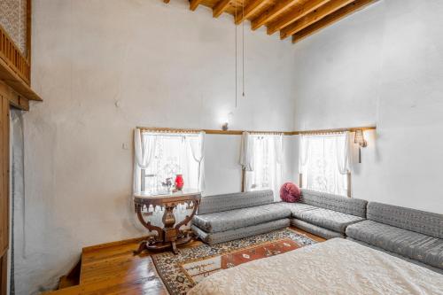 a living room with a gray couch and a window at Ha La Bodrum in Bodrum City