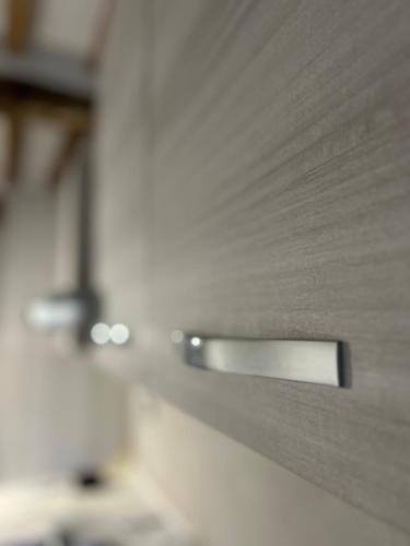 a close up of a metal door in a kitchen at Borgo House in Abbadia San Salvatore