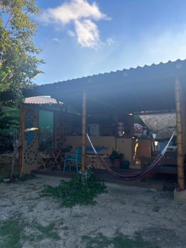 una casa con un'amaca di fronte di Corumbau cura - Camping a Corumbau