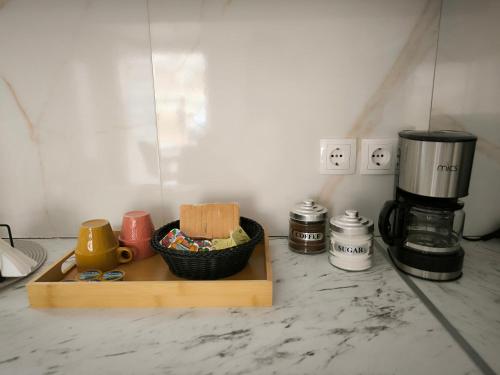 a counter with a bowl of bread and a coffee maker at Livadi apt in Paránimfoi