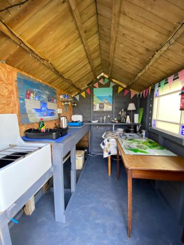 a kitchen with a table and a counter top at Berty the campervan in Carbis Bay