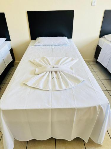Ένα ή περισσότερα κρεβάτια σε δωμάτιο στο Hotel Central Plaza Timóteo