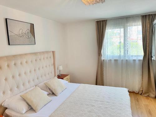 a bedroom with a white bed and a window at Apartment Matea in Split