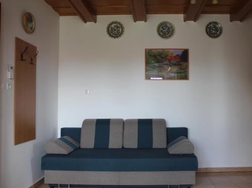 a blue couch sitting in a living room at Laura Villa in Veľký Meder
