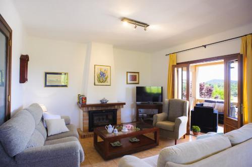 a living room with two couches and a television at Finca Miquel Tomas in Caʼs Concos