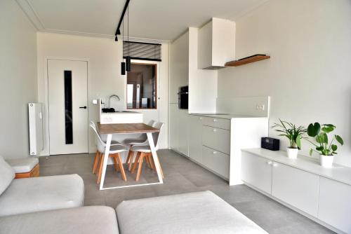 kuchnia i salon ze stołem i kanapą w obiekcie Ostend Sea View Apartment w Ostendzie